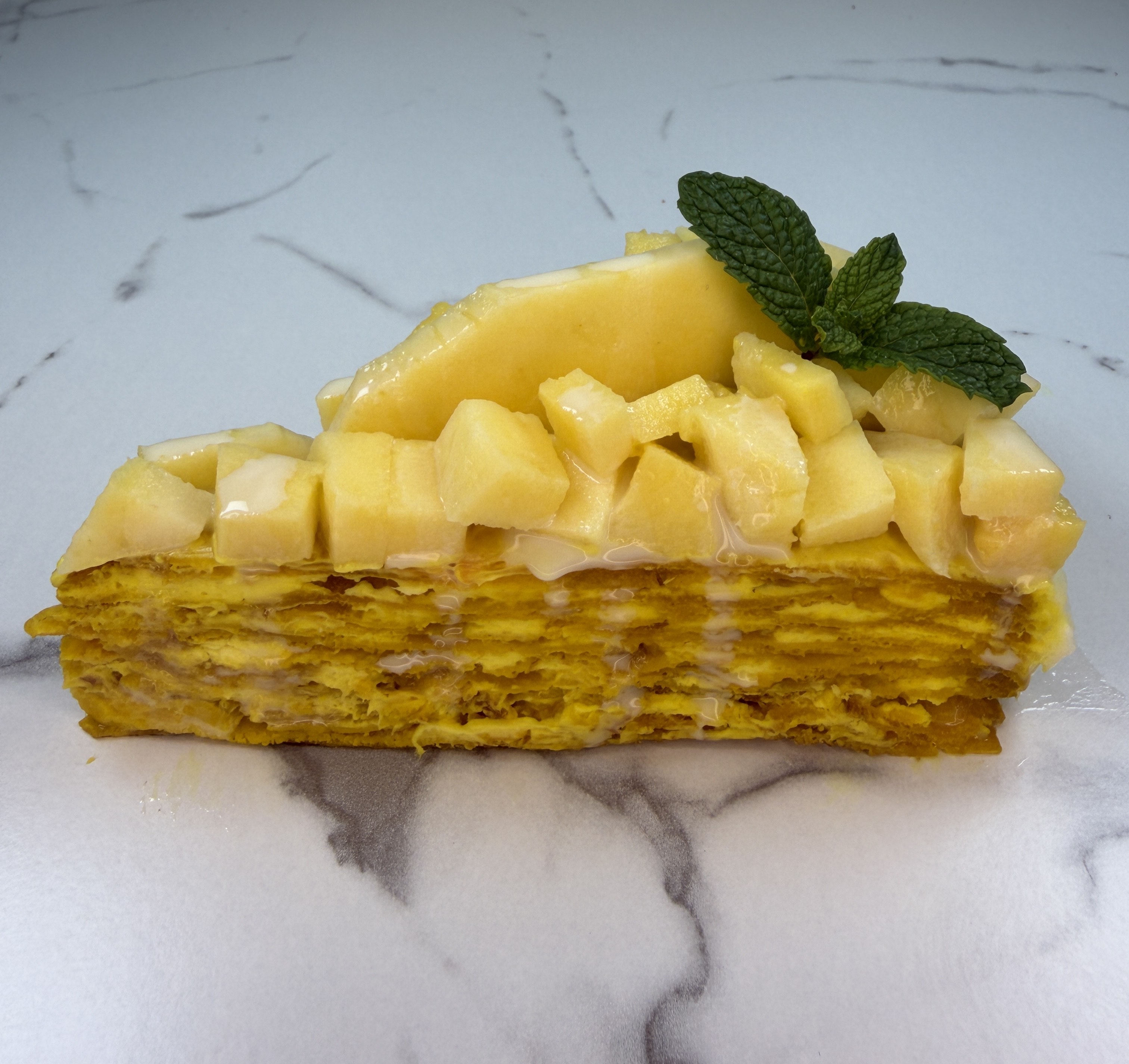 Beautiful mango cake with layers of cream and fresh mango.